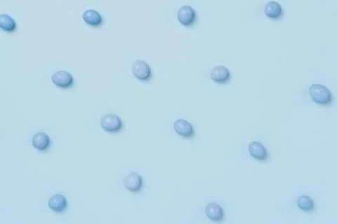 Blue easter dragee on a blue background Stock Photos
