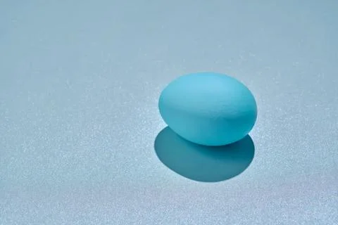 Blue Easter egg on a blue background. Stock Photos