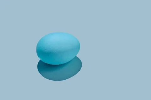 Blue Easter egg on a blue background. Stock Photos