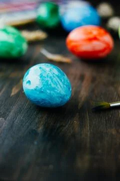 Blue easter egg like planet Earth on brown wooden table. Stock Photos