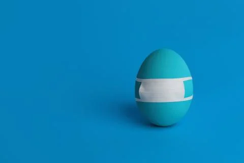 Blue Easter egg in protective medicine mask. Coronavirus Easter. Stock Photos