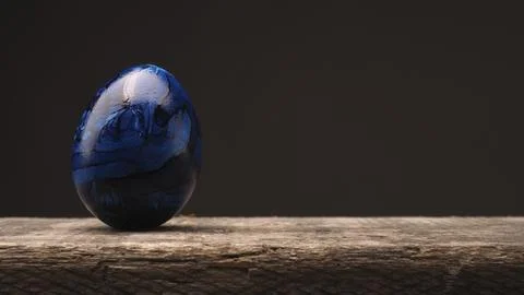 Blue Easter egg on a rustic wooden table with space for text or image, Happy Stock Photos