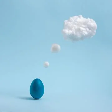 Blue Easter egg is thinking on pastel blue background. Comic book motive. Stock Photos