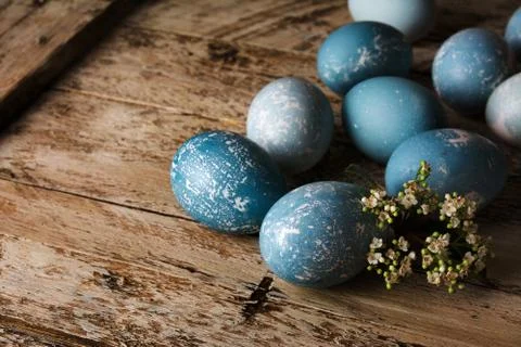 Blue Easter eggs and bouquet of flowers wooden table Stock Photos