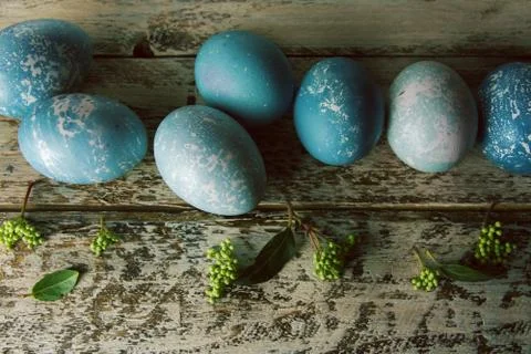 Blue Easter eggs and bouquet of flowers wooden table Stock Photos