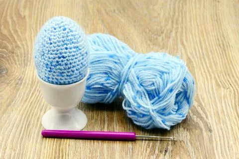 Blue easter eggs crochet of wool in egg cup. wooden background Stock Photos