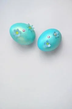 Blue Easter eggs with flowers on a gray background. Stock Photos