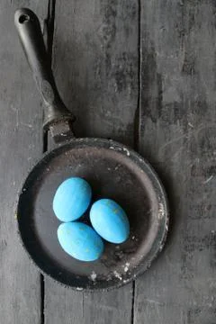 Blue Easter eggs in a frying pan art, holiday decoration Stock Photos