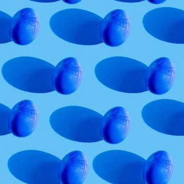 Blue Easter eggs with a shadow on a blue background seamless pattern Stock Photos