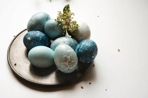 Blue Easter eggs on tin plate, decorated with flowers Stock Photos