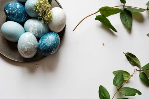 Blue Easter eggs on tin plate, decorated with flowers Stock Photos