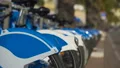 Blue eco-bicycles standing in row on street, bikes for hire, urban transport HD Footage