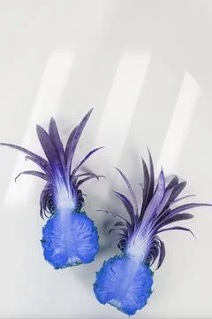 Blue effect pineapple cut in half on off white background Stock Photos