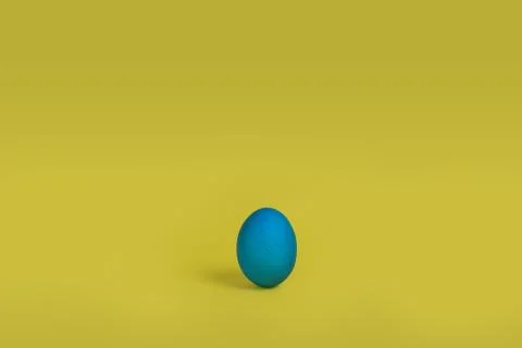 Blue egg on yellow background Stock Photos