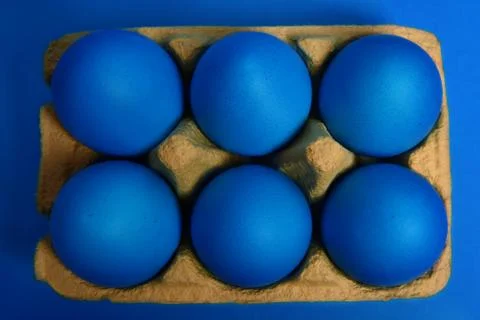 Blue eggs on blue background Stock Photos
