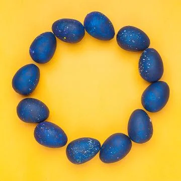 Blue eggs on a yellow background. Circle shape. trendy Easter egg of color of Stock Photos