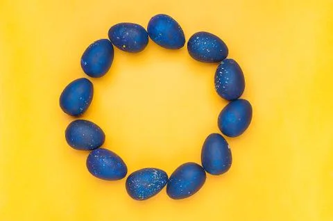 Blue eggs on a yellow background. Circle shape. trendy Easter egg of color of Stock Photos