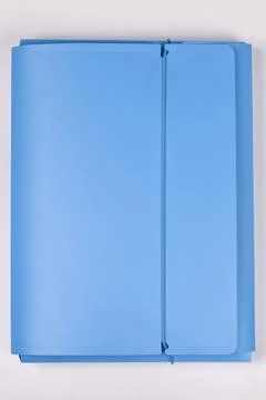Blue elasticated document folder on pink background Stock Photos