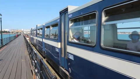 Blue electric train carriages rushing past on Southend Pier railway Stock Footage 145938535