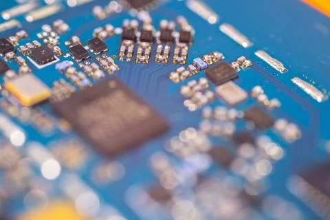 Blue electronic circuit board with microchips, capacitors, resistors, metal.. Stock Photos