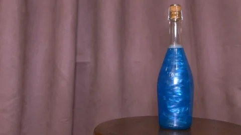 Blue elixir in a bottle Stock Footage 93903019