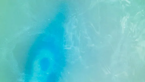 Blue elixir bottle pulled from the water Stock Footage 93315284