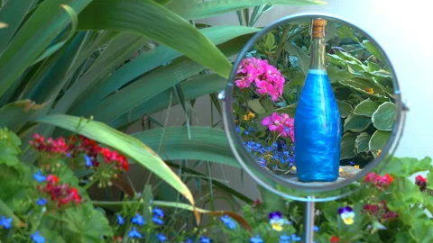 Blue elixir in the bottle is reflected in the mirror Stock Footage 93313480