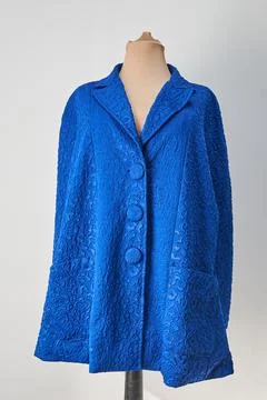 Blue embossed fabric jacket with blue buttons. Formal wear, autumn coat Stock Photos