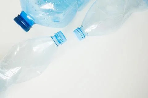 Blue empty plastic bottles on white background with copy space close up. Ec.. Stock-Fotos