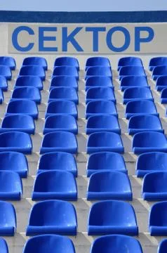 The blue empty plastic stadium chairs with the inscription:  Stock Photos