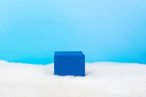 Blue empty stand on blue shadow background and white fluffy bottom. Blank unb Stock Photos