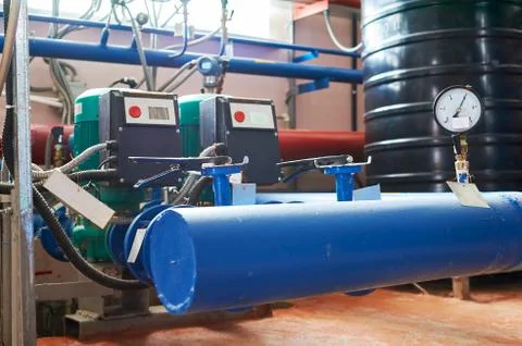 Blue engine with a pump and a frequency converter connected to the blue pipes Stock Photos