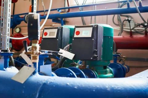 Blue engine with a pump and a frequency converter connected to the blue pipes 스톡 사진