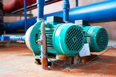 Blue engine with a pump connected to the blue pipes. Stock Photos