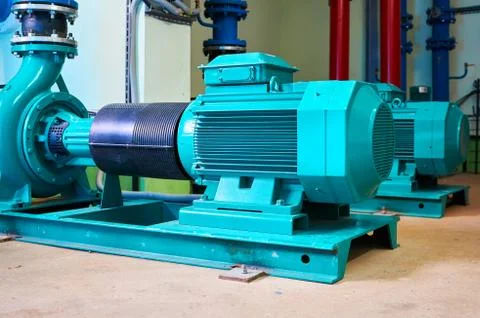 Blue engine with a pump standing on a metal stand. Stock Photos