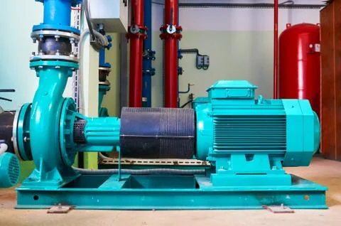 Blue engine with a pump standing on a metal stand. Stock Photos