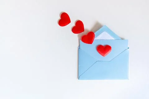 Blue envelope and flying red hearts on white background Stock Photos