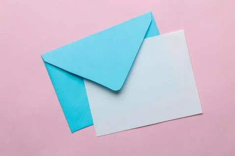 Blue envelope with a blank for text on a bright trendy pink background. top v Stock Photos