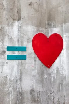 Blue equal sign and red wooden heart Stock Photos