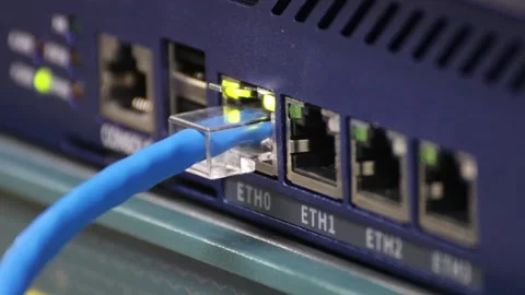 Blue Ethernet cable connected to a gigabit network switch Stock Footage 326576581