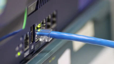 Blue Ethernet cable connected to a gigabit network switch Stock Footage 326576583