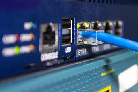 Blue ethernet cable connected to network device Foto stock