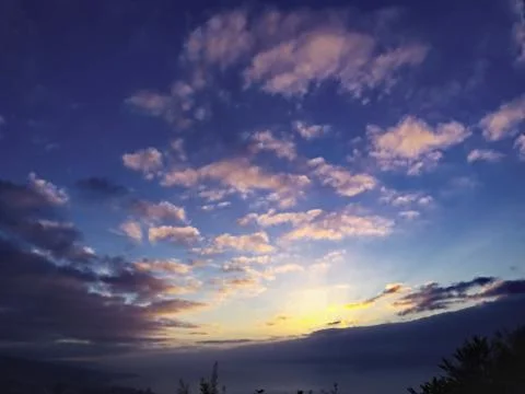 Blue evening sky with light-filled shred clouds in pink, illuminated Stock Photos