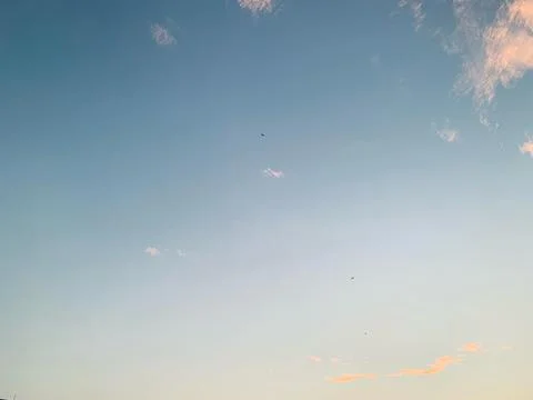 Blue Evening Sky with Soft Clouds and Bird Silhouettes in Jakarta Stock Photos