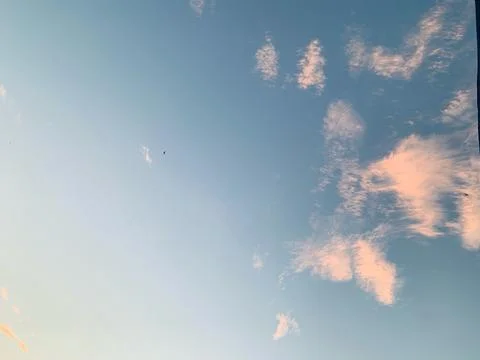 Blue Evening Sky with Soft Clouds and Bird Silhouettes in Jakarta Stock Photos