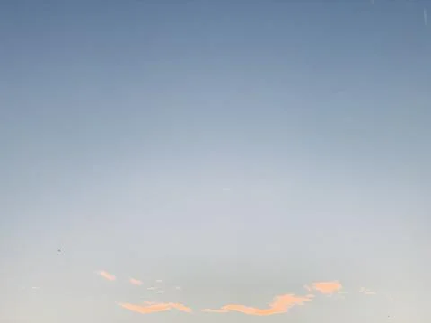 Blue Evening Sky with Soft Clouds and Bird Silhouettes in Jakarta Stock-Fotos