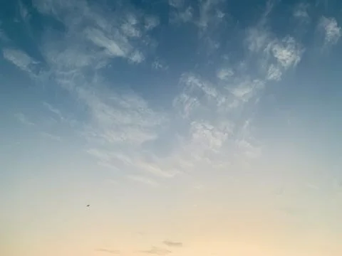 Blue Evening Sky with Wispy Clouds and Crescent Moon over Jakarta Stock Photos