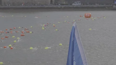Blue Event Flag With Mass Swimmers In Gan River Open Water Race Stock-Footage 343554621