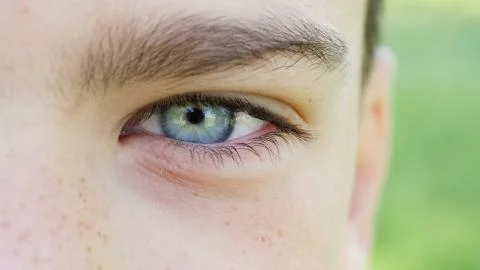 The blue eye of a boy closeup Stock Photos