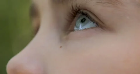 Blue Eye of Child Looking up Closeup. Person Looking Up at Sky in Outdoors... Stock Footage 304826646